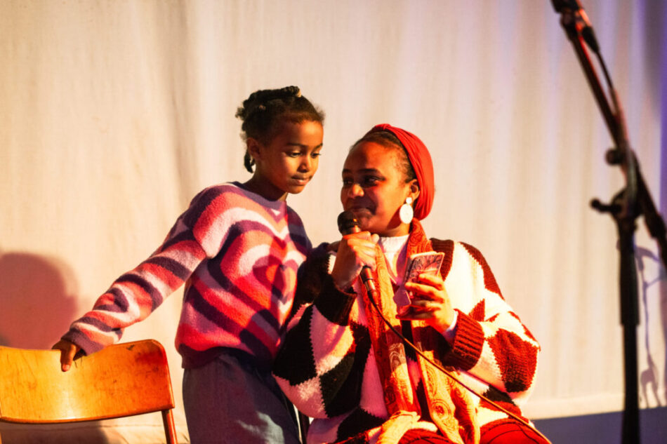 A mother and daughter performing poetry.